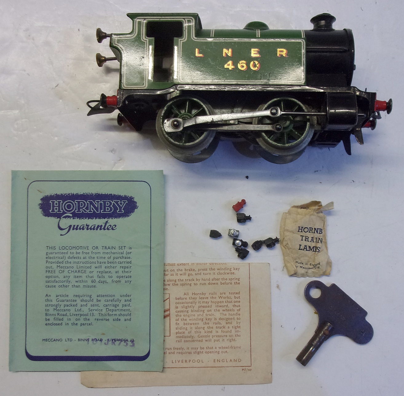 Hornby O Gauge Clockwork Tank Loco.  Boxed, unused complete with key.  Original guarantee etc also a pack of loco lamps.