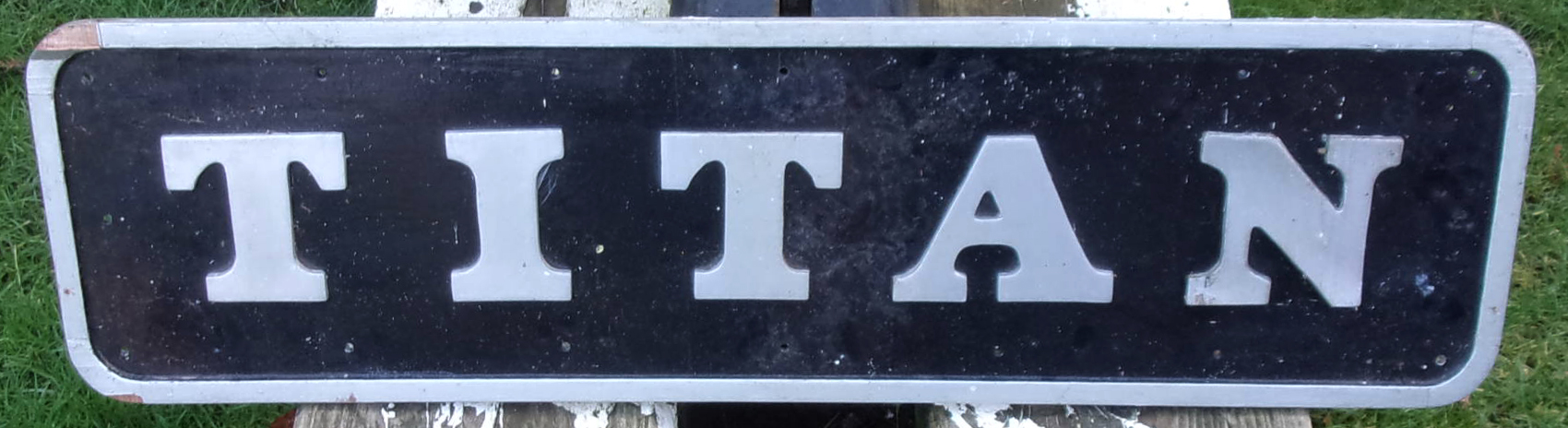 Repro Nameplate "Titan".  Wooden construction.  30" x 8".  Needs a little tlc.