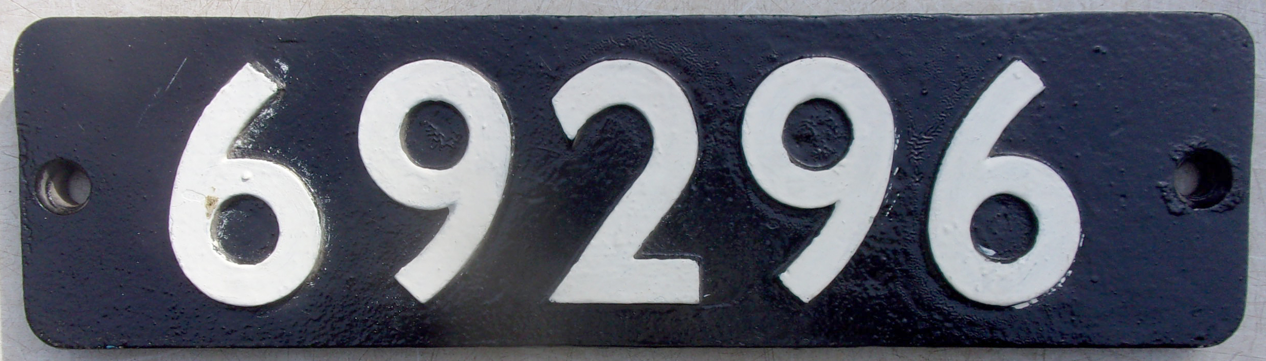 Smokebox Numberplate "69296", as carried by MS&L Railway, Class No. 5 0-6-2 Tank loco, designed by Parker. Built Gorton Works in 1896. Allocations included Gorton, Sheffield, Darnall. Withdrawn in 1960, 64 years plus service. 131 built which 21 reached BR days. Quickly replaced by diesel shunters. The last six were withdrawn in 1960. '69296' was one of these. Repainted face, ex loco back with pattern shop casting marks, This plate was purchased by the vendors husband direct from BR for 10 shillings, £0.50p in todays money. Copy of BR letter accompanies this lot. 3 x images to view.