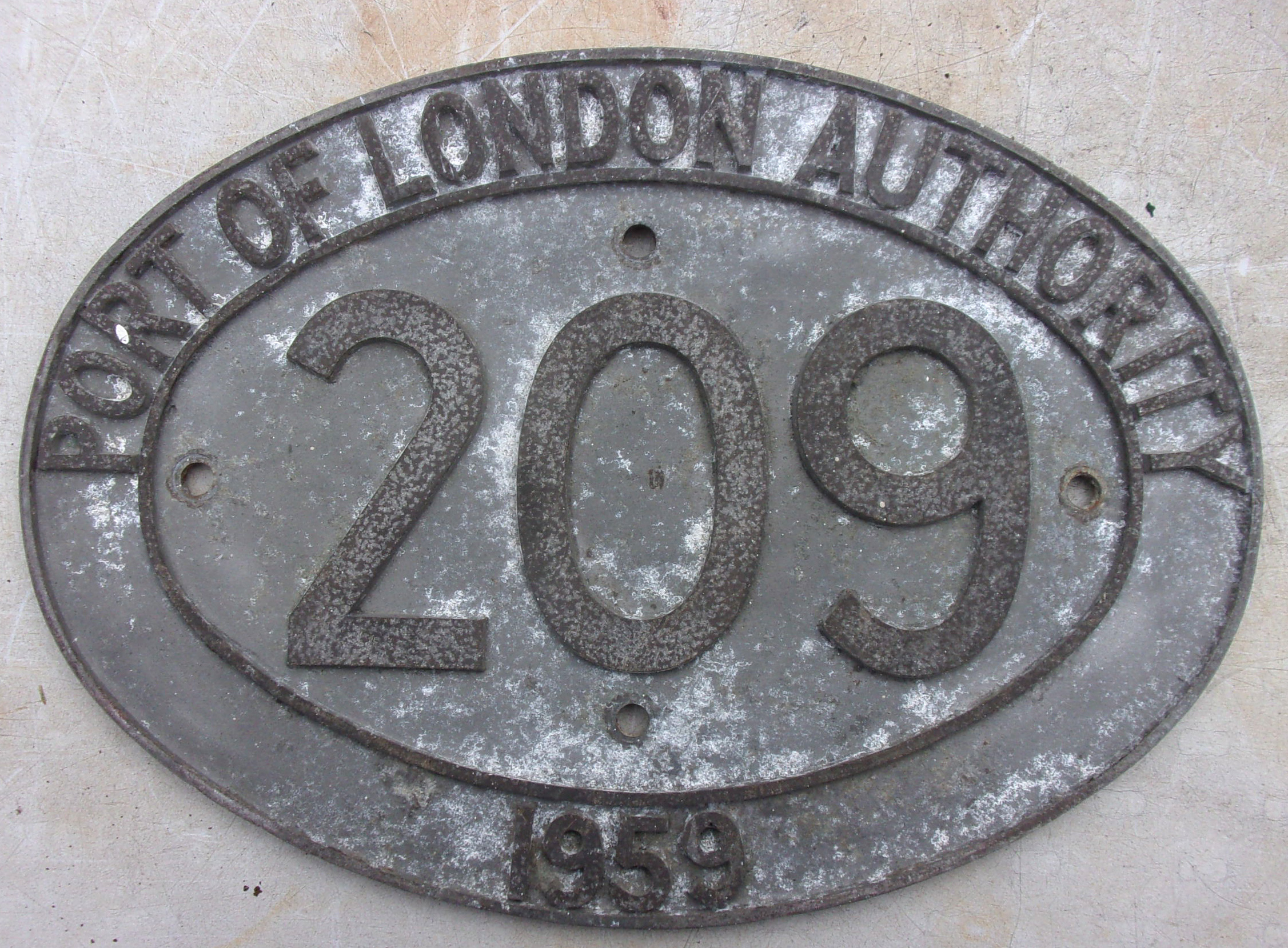 Cabside Numberplate "PORT OF LONDON AUTHORITY 209 1959", as carried by diesel 0-6-0 shunter, built by the Yorkshire Engine Company to replace the steam fleet.  Devoid of paint.  Cast aluminium.  16 1/2" x 12"