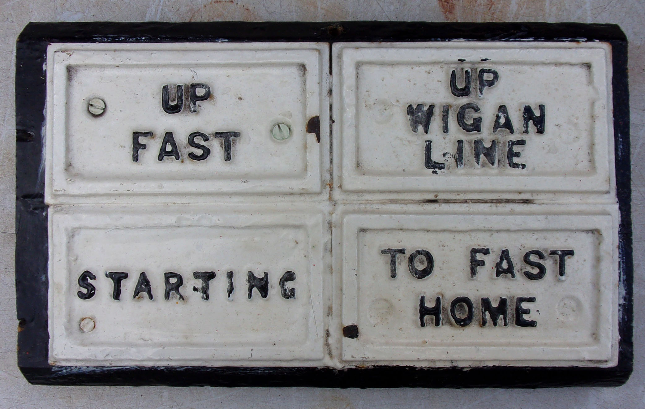 A small section of L&Y Signal Lever Back Board with original cast iron plates still attached, from Lostock Junction Signal Box.