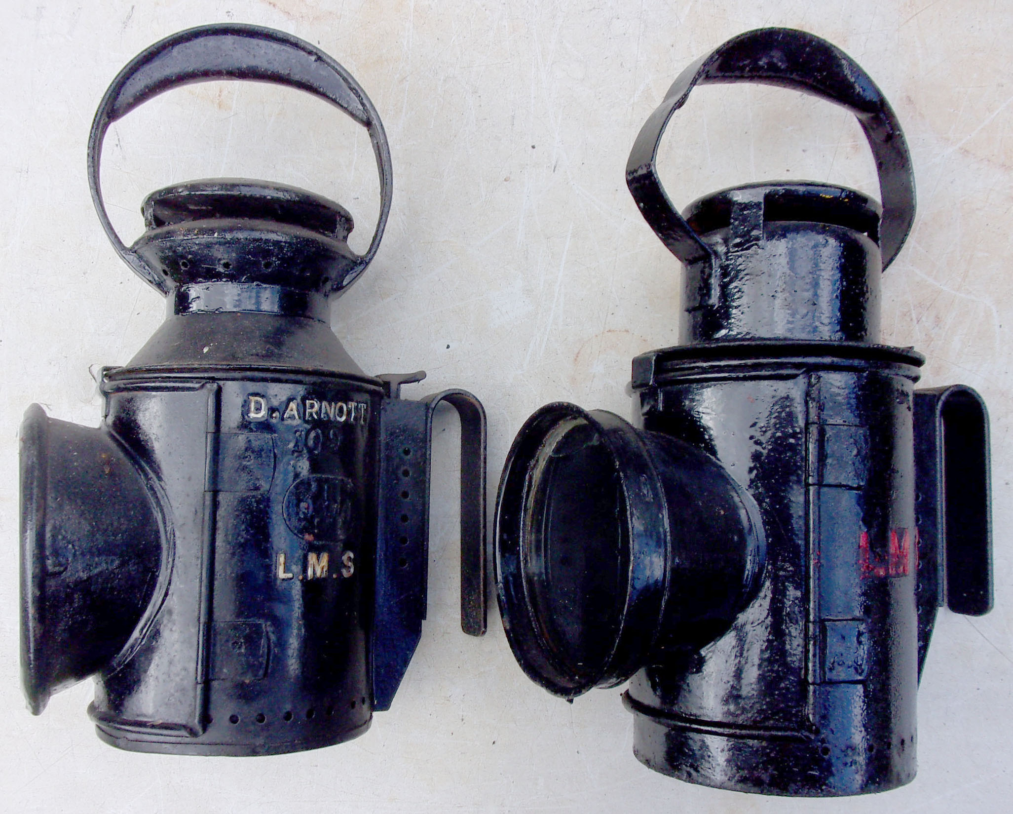 2 x LMS Handlamps, one stamped "D. Arnott", accompanied by a War Time Pattern Lamp. Complete with all fittings.