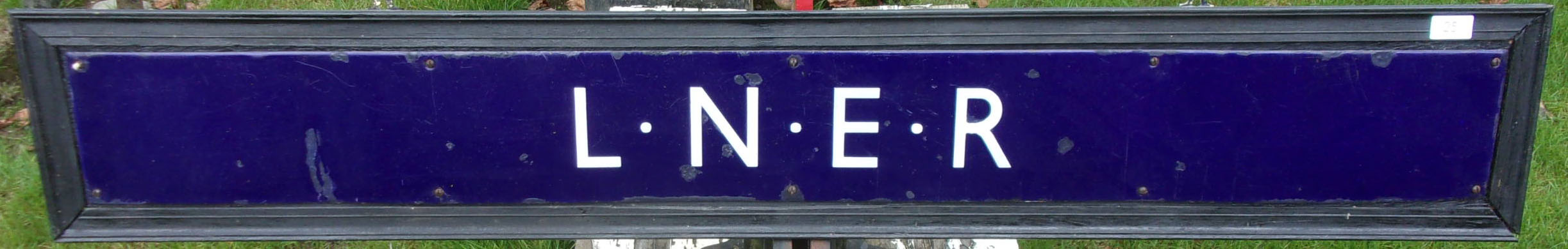 Enamel QR Poster Board Header "LNER", mounted on attractive backboad. Very good colour & shine, edge nibbles and some small chips, repainted, touched in.