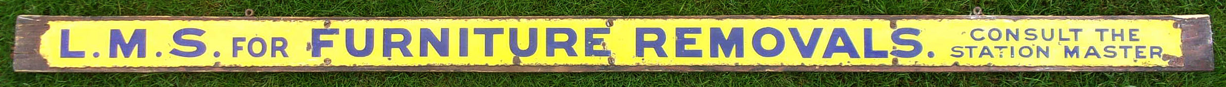 LMS Advertising Sign "LMS FOR FURNITURE REMOVALS CONSULT THE STATION MASTER", probably from an internal bridge on a large terminus station. These were attached to the step riser panel. Very good colour & shine, displayed on a wooden board. 58" x 3".