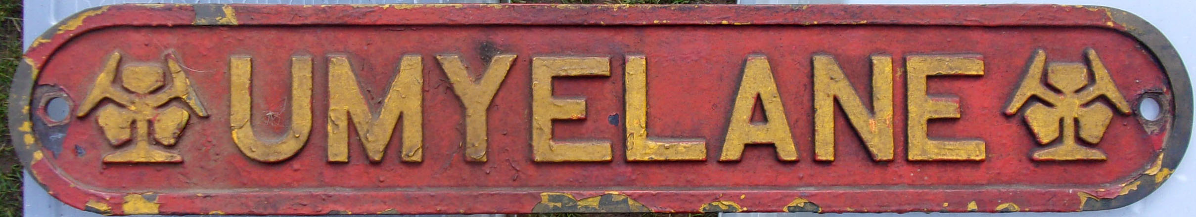 Locomotive Nameplate "UMYELAME", as carried by Rhodesian Rly Class 15th Garratt Loco No. 386. Built by Beyer Peacock, Manchester 1948. Ex loco condition. 34 1/2" x 6". Embossed cast brass.